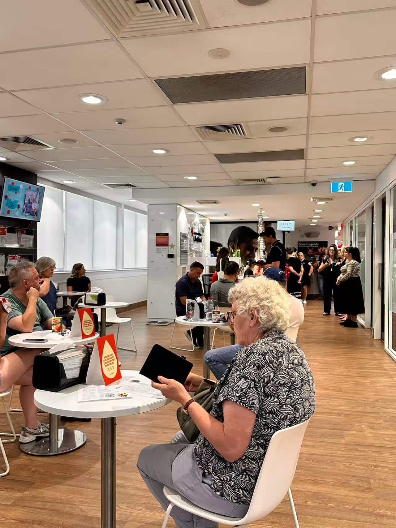 Blood donors quietly line up, waiting to donate blood.