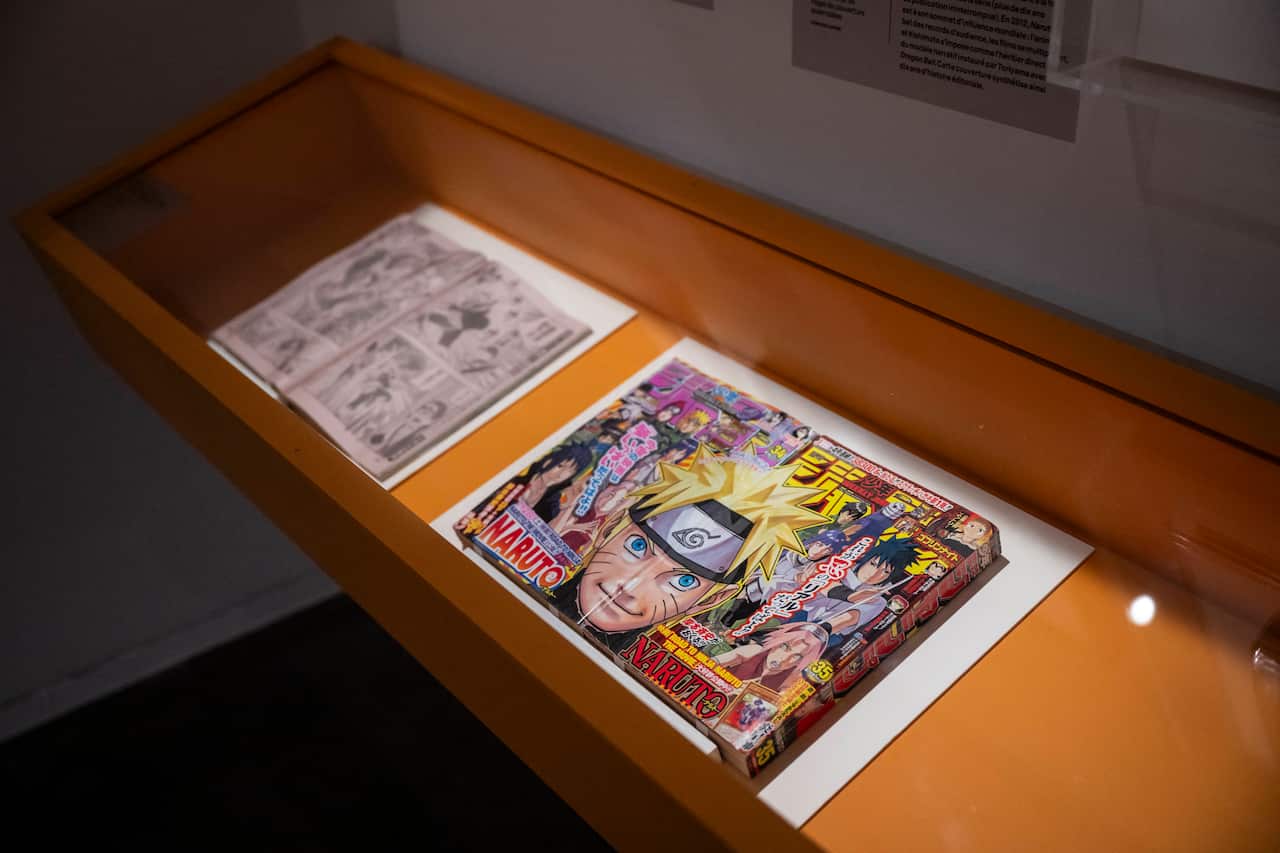 A display case with Japanese manga artwork inside.