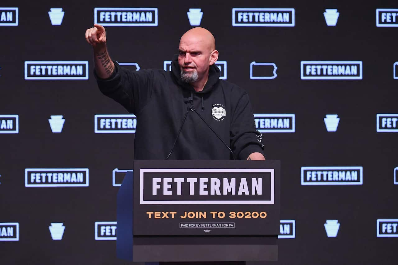 A man stands on the podium in front of the microphone.