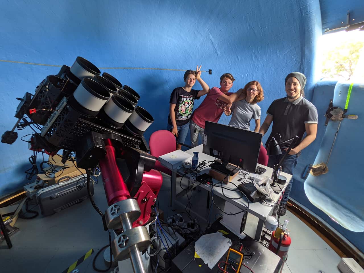 Orsola De Marco in 2022 with her children and a Macquarie University student at the Huntsman Telescope.
