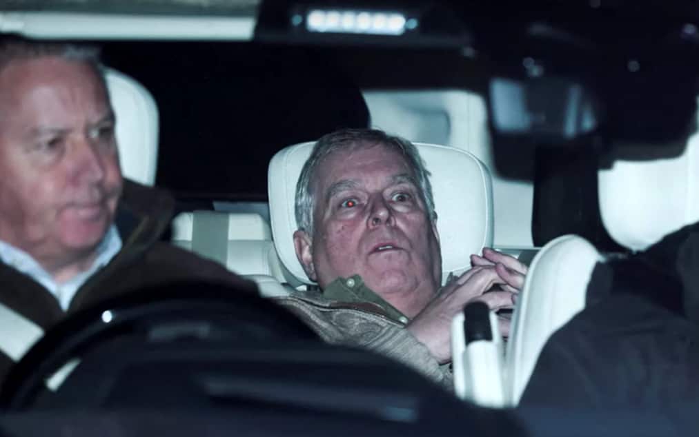 Andrew Mountbatten-Windsor with a shocked expression in the backseat of a car.