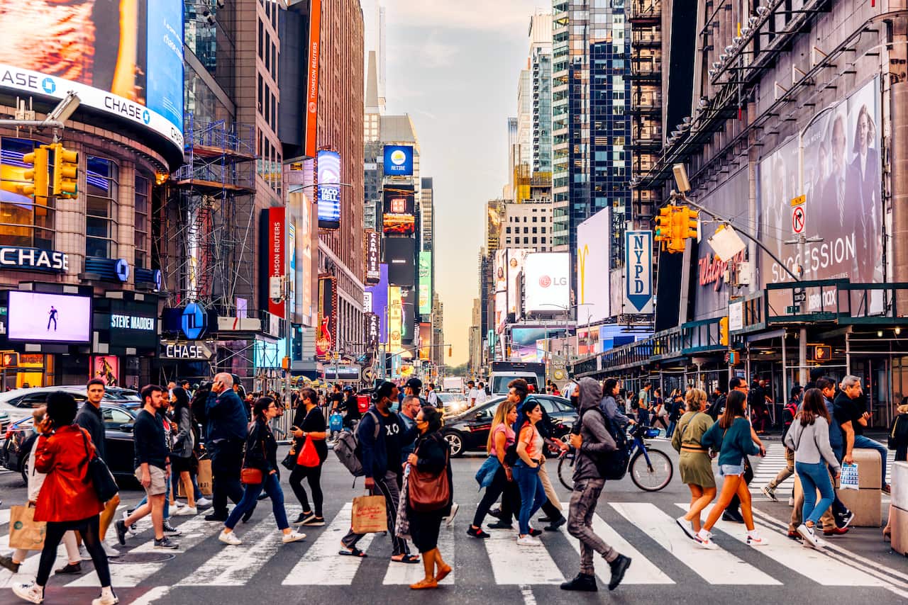 A crowd of people crossing a road in New York City