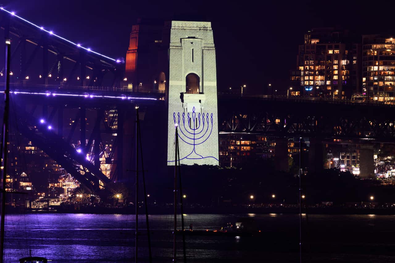 A menorah is projected onto the pylon of a bridge