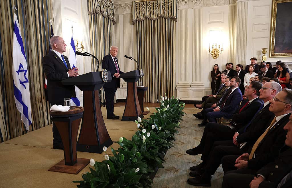 Two men in suits address a press conference.