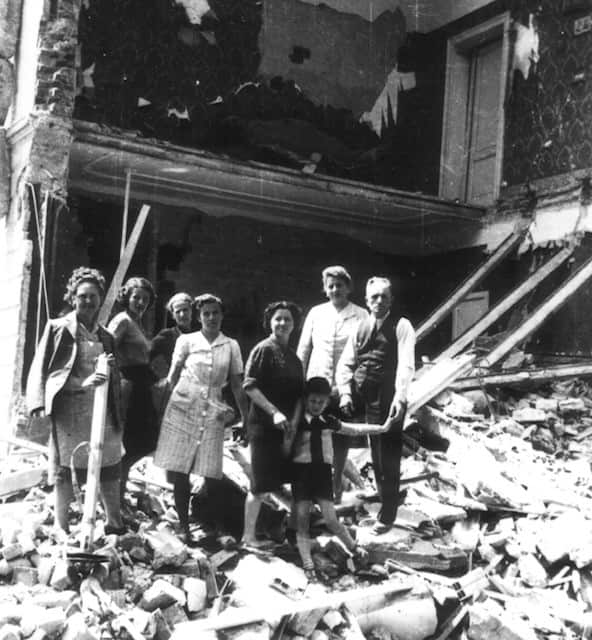 The Maneschi family in front of the rubbles of their house after it was bombed in 1944.
