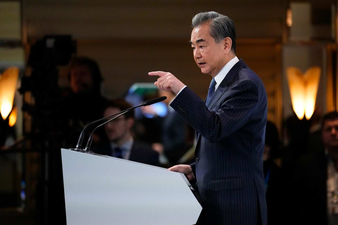 A man speaks at a lectern.