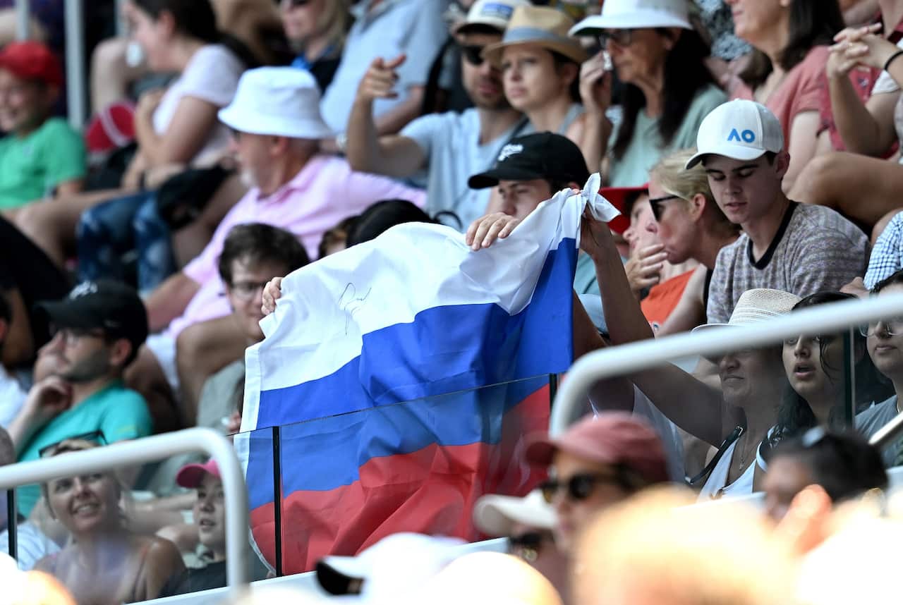 A Russian flag is displayed by spectators at the Australian Tennis Open (AAP)