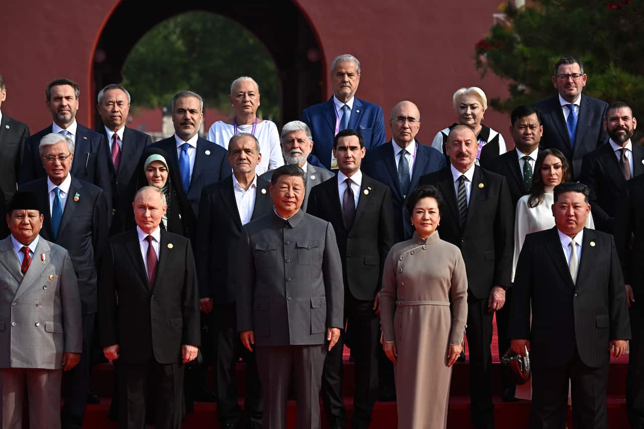 A group photo of men and women in formal attire.