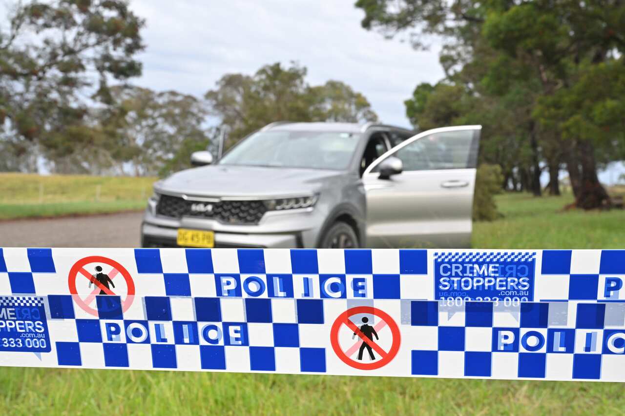Police tape in front of a car